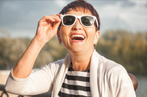 older woman wearing white sunglasses